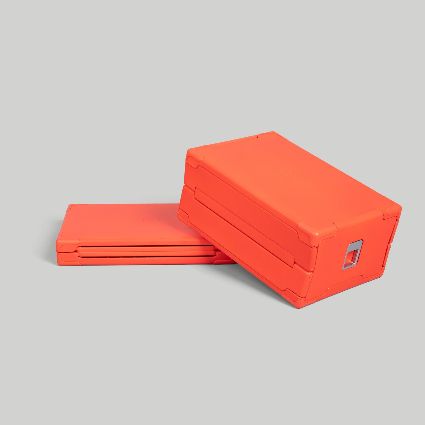 SUNSAL collapsible yoga block in Coral, shown expanded and collapsed, on a light grey background