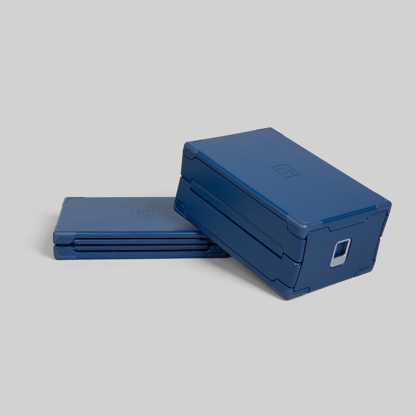 SUNSAL collapsible yoga block in Navy, shown expanded and collapsed, on a light grey background