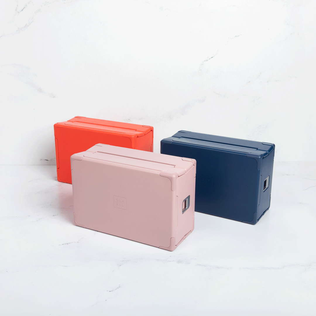 GIF showing Sunsal yoga blocks in Coral, Rosewood, and Navy transitioning between expanded and collapsed states, showcasing functionality and modern design